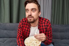 shocked-man-eating-popcorn-watching-movie-surprised-handsome-bearded-male-fresh-suspense-tv-wi...jpg