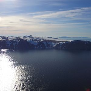 Big Diomede Island with mainland Russia In Background